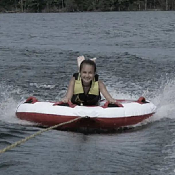 happy kid tubing on Beaver Lake in Arkansas